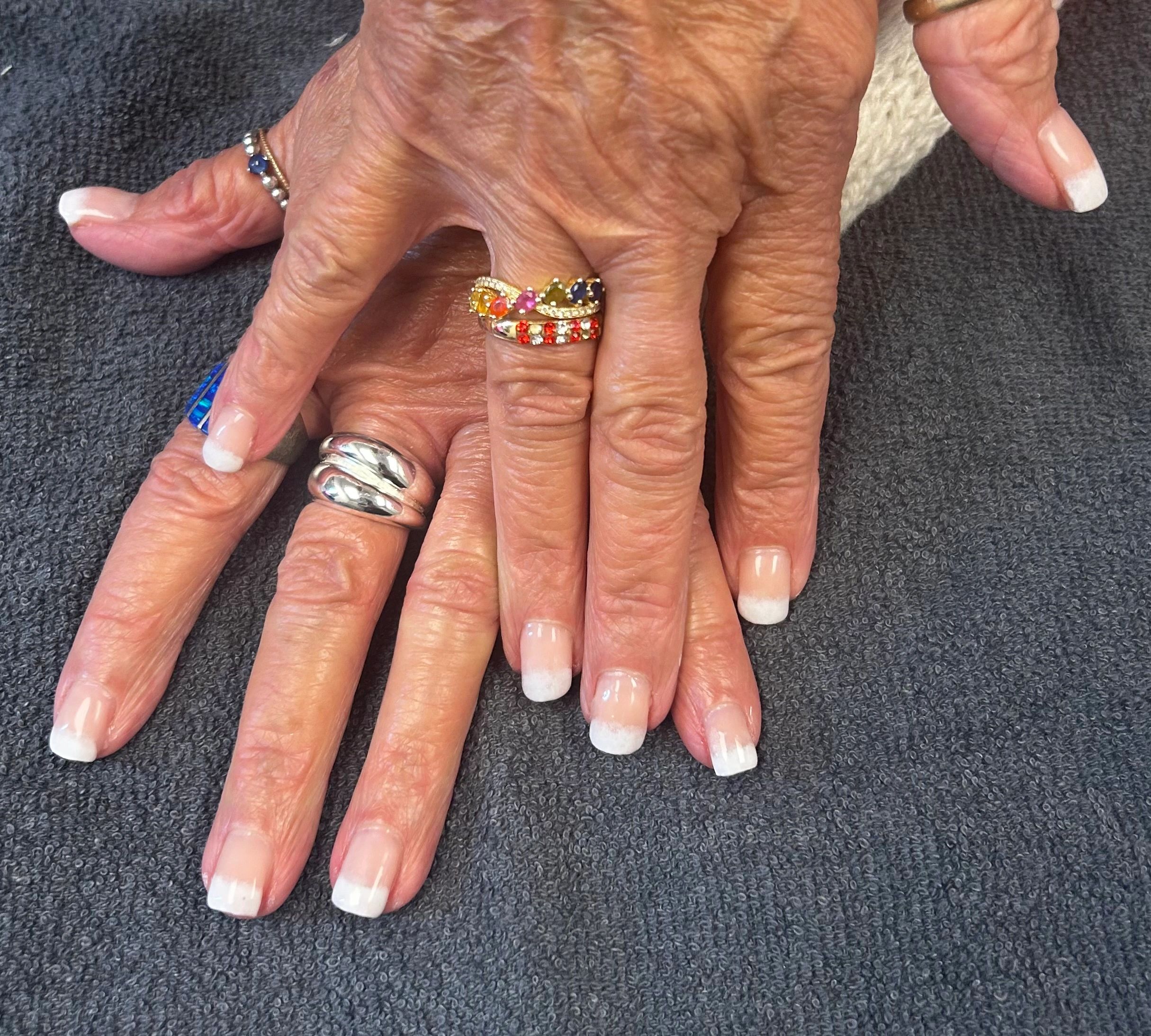 French manicure with engagement ring